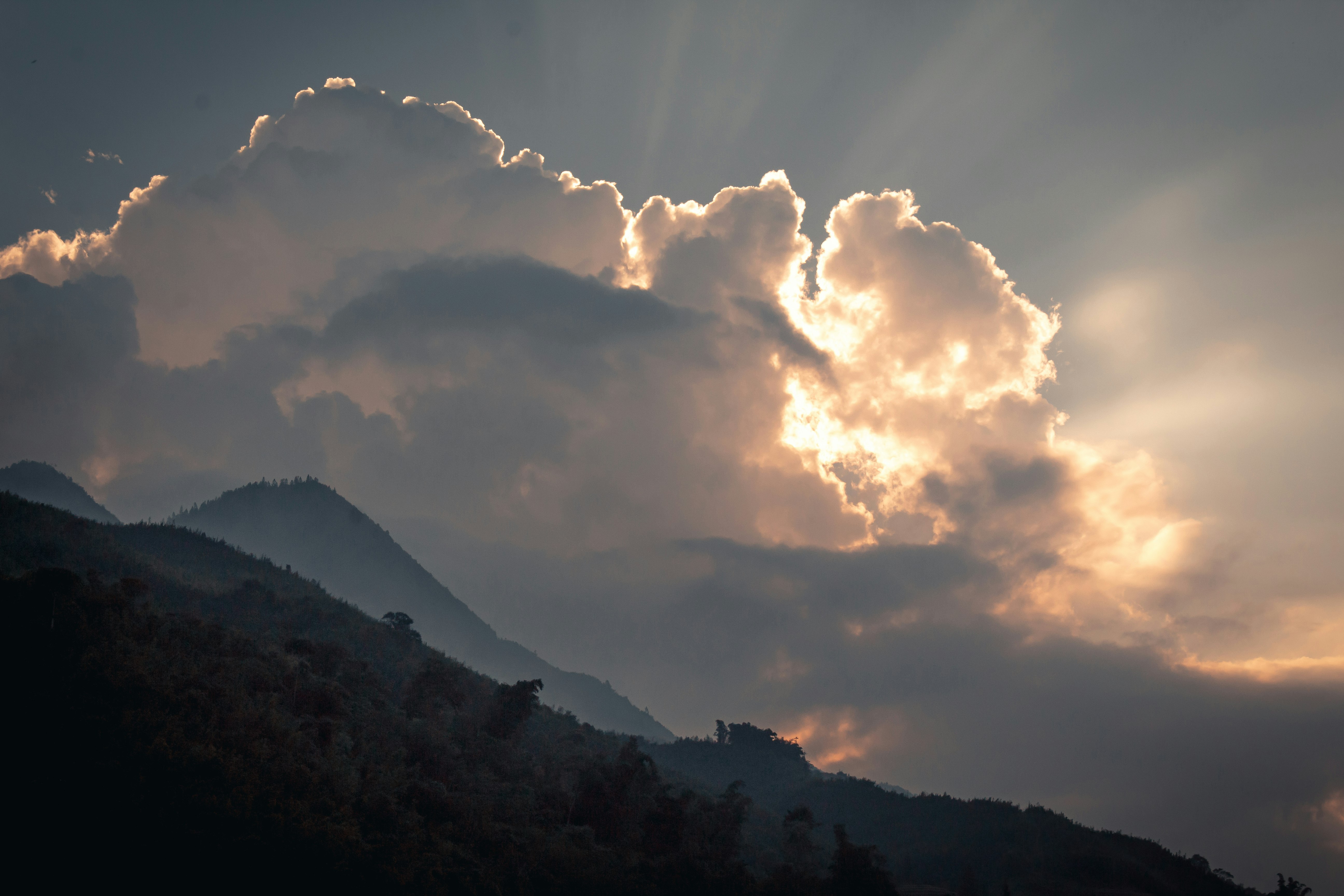 white clouds over mountain during daytime